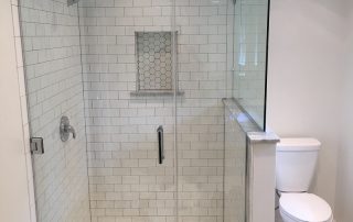 remodeled shower with white tile