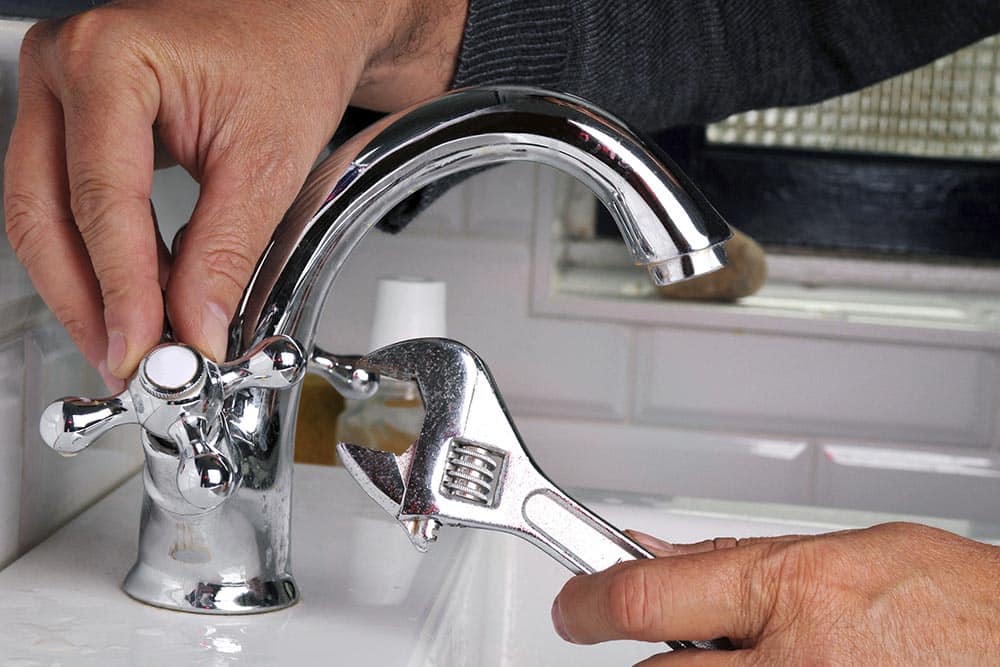 Filling glass of water from stainless steel kitchen faucet